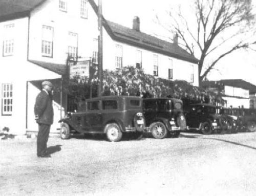 1930-1939 Hotel Calvert, with man and 7 automobiles, Prince Frederick, Md