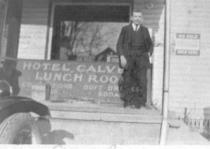 1930-1939 Man (Eugene Bowen) in front of Hotel Calvert Lunch room