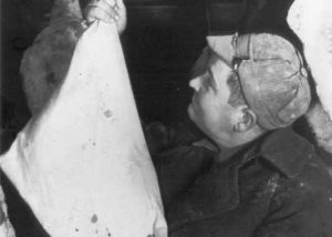 1940-1949 Hanging up salted pork in muslin bag